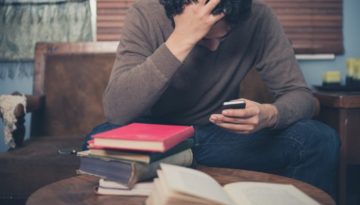 distressed individual looking at his phone